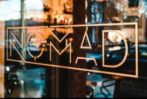 Nomad restaurant sign on door